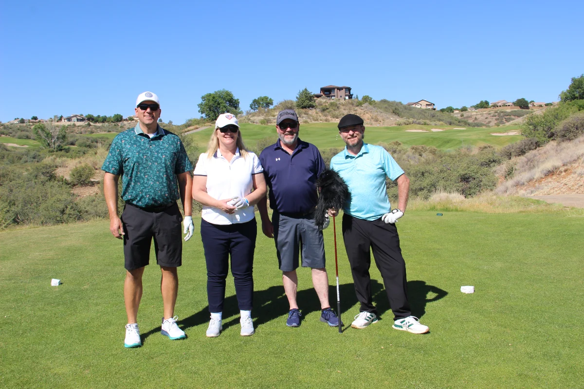 Four golfers pose for a team photo during the Live United Golf Classic at StoneRidge Golf Course