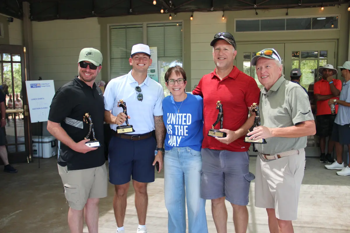 Men's division champions pose with trophies at the Live United Golf Classic awards ceremony