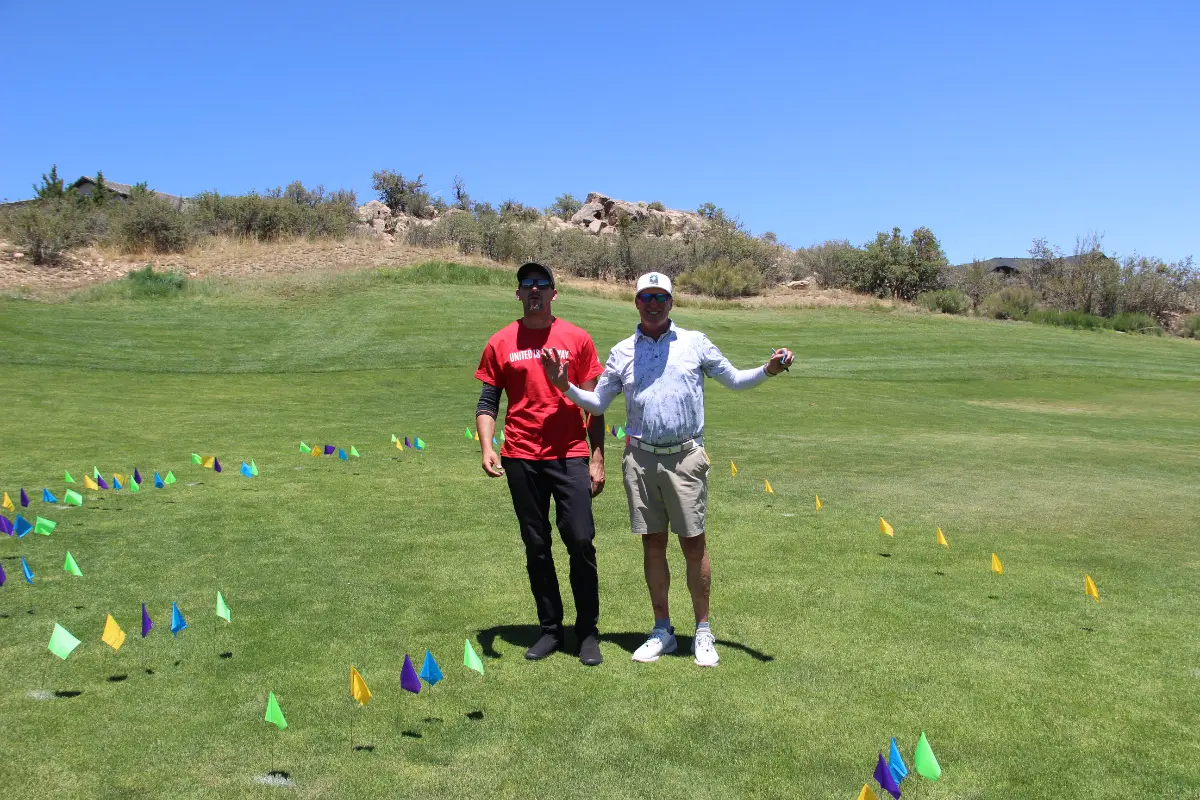 Participants stand within a marked challenge area during the Live United Golf Classic