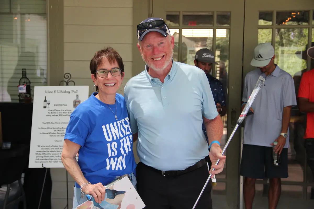 Golf tournament participant receives recognition during the Live United Golf Classic awards event